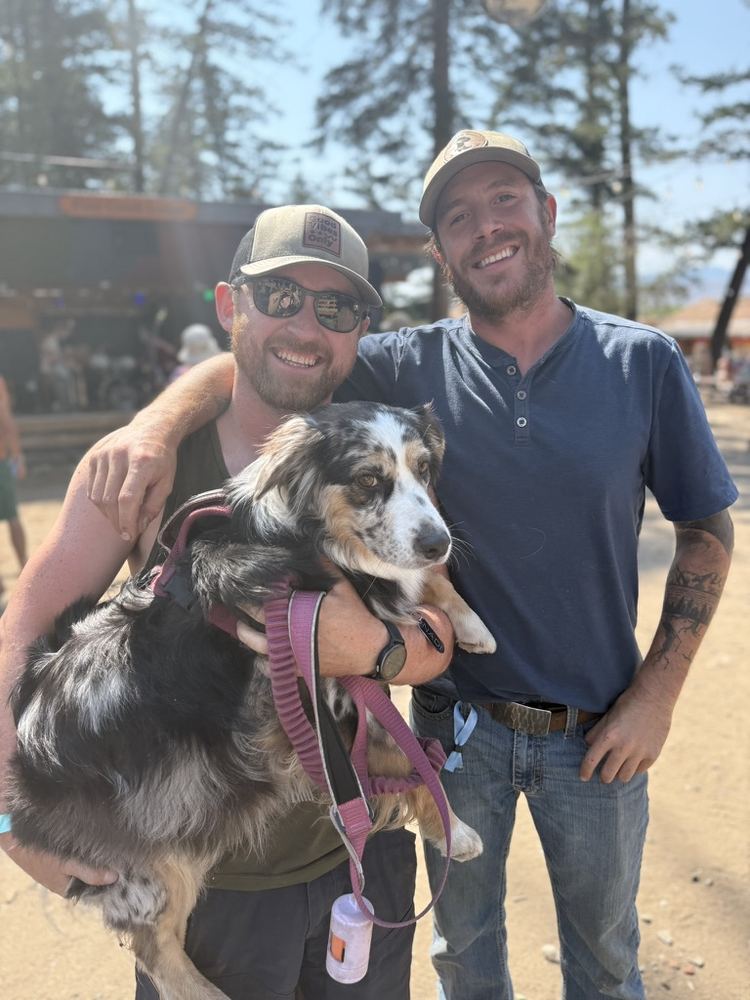 With a friend and a dog at an outdoor gathering