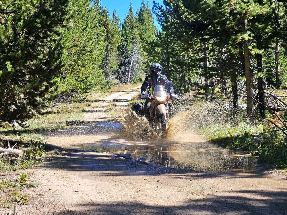 Riding through a water crossing on a forest two-track